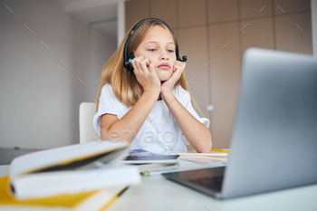 r hands while staring blankly at her laptop