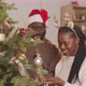 Happy African-American Couple Decorating Christmas Tree - VideoHive Item for Sale