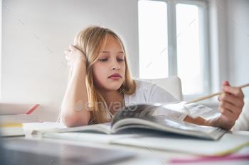 Upset young person pressing a page with a pencil