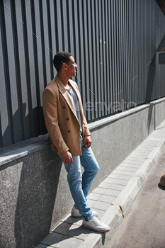 Young brunette man enjoying sunny day in the city / Photodune, Misc