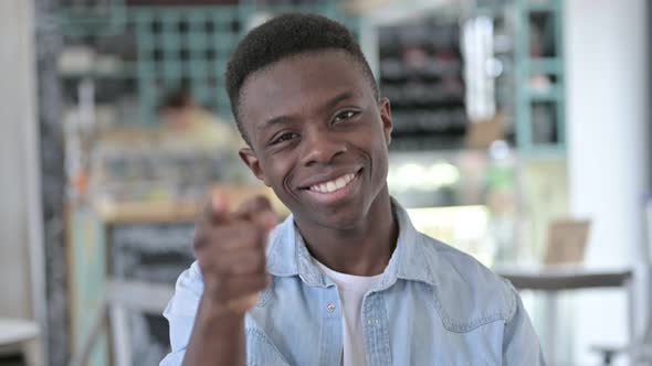 Happy African Man Pointing with Finger