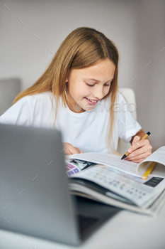 schoolwork in a workbook, lying on a grammar dictionary