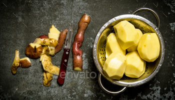 The concept of wet peeled potatoes on the stone table . / Photodune, Misc