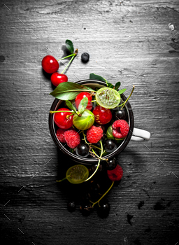 Berries in a mug. On black wooden background. / Photodune, Misc