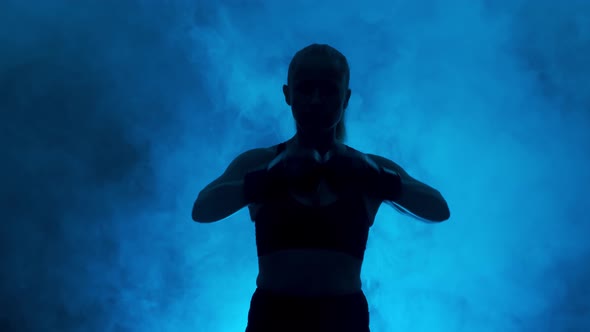 Silhouette of female boxer showing muscles 