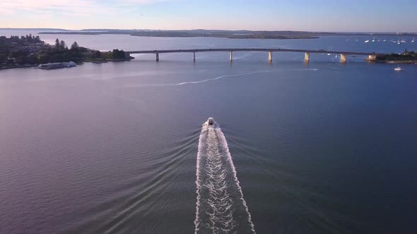 Aerial speed boat chasing and following by the drone at golden hour sunrise. Taren Point, Sydney Aus