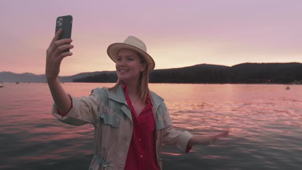 Modern Technology Lifestyle Woman Using Mobile Phone at Lake Tahoe Sunset