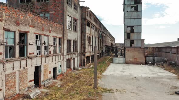 Aerial view of an old factory ruin and broken windows. Old industrial building for demolition.