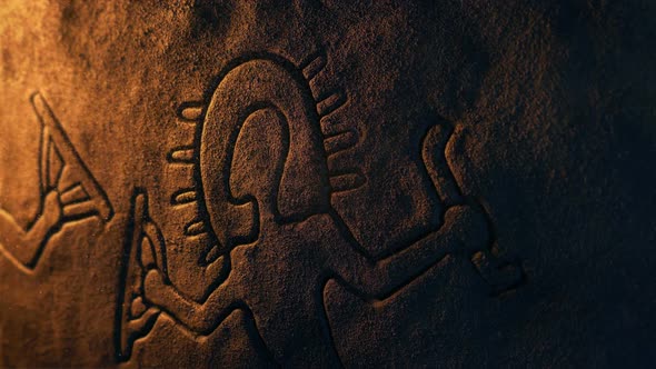 Light Shines On Ancient Man Carving In Dusty Cave