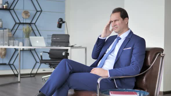 Headache, Businessman with Pain In Head Sitting on Sofa