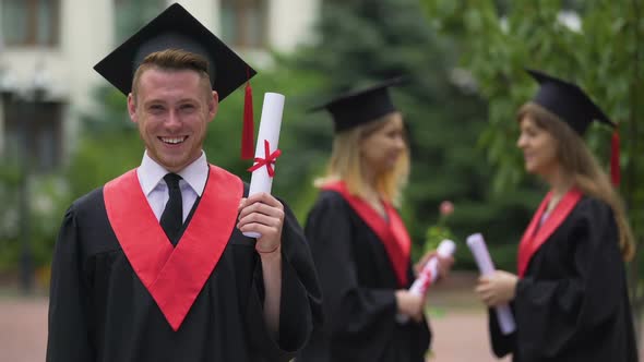 Laughing Graduate Rejoicing Diploma and Graduation Ceremony, Happiness