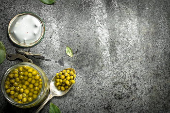 Marinated green peas in glass jar. / Photodune, Misc