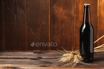 Beer bottle on wooden background / Photodune, Misc
