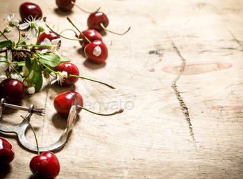 Red cherry and metal tool for cherries. / Photodune, Misc