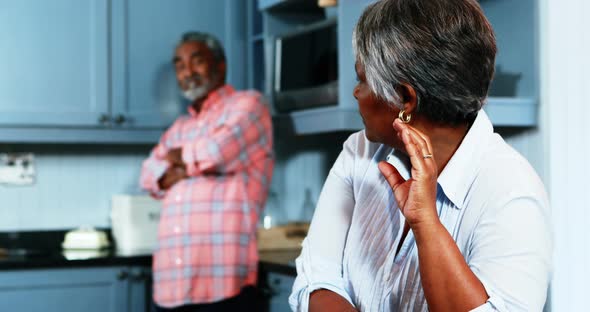 Senior couple ignoring with each other in kitchen