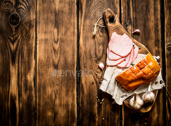 Ham with garlic and spices on the old Board. / Photodune, Misc