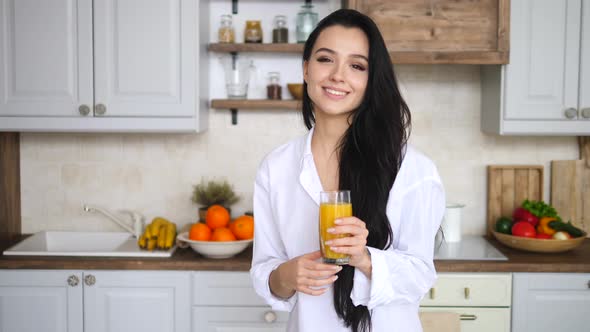 Young Female With Orange Juice On Kitchen At Home, Healthy Diet Concept