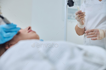 Focused image of physician arms during medical procedure in beauty clinic / Photodune, Misc