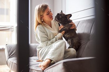 Caucasian female looking into the dog face / Photodune, Misc