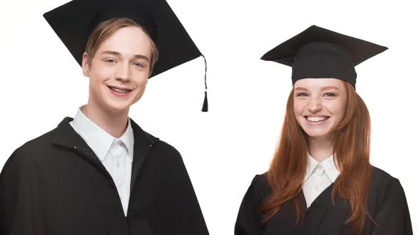 Happy Young Caucasian Graduate Male and Female in Black Robes and Square Academical Caps Laughing