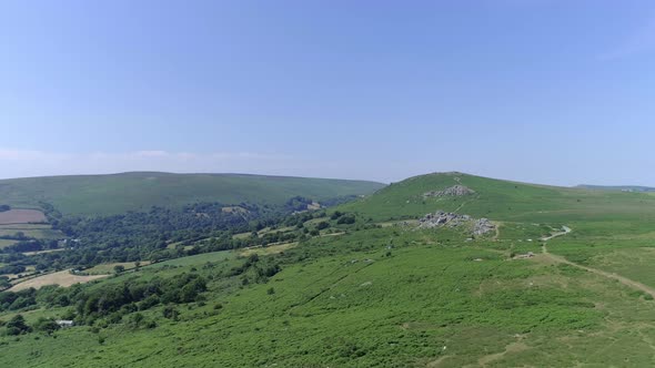 Bonehill Rocks, Wide shot aerial tracking forward over the wide expanse of Dartmoor, tors, grassy mo