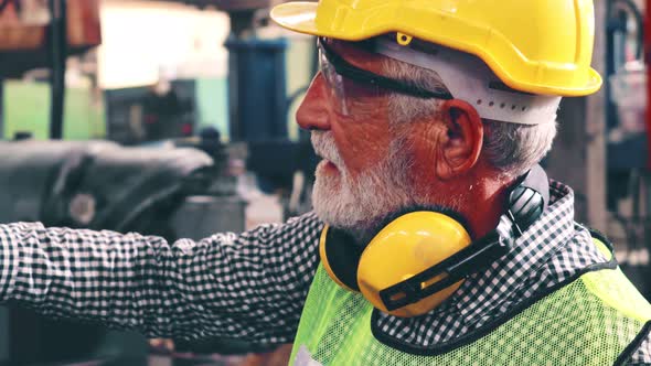 Senior Factory Worker Teach How to Use Machine Equipment in the Factory Workshop