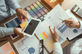 Business partnership coworkers using a tablet to chart company financial statements report - PhotoDune Item for Sale
