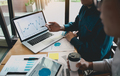 Business partnership pointing to the graph of the company financial statements report - PhotoDune Item for Sale