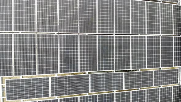 Aerial View Panorama of Solar Panels. Slow Movement of the Camera Over the Panels. Background