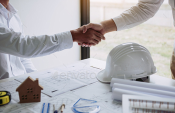 Two engineering man with construction worker greeting a foreman at renovating apartment. / Photodune, Misc