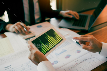 businessmen are working analyzing the company annual budget / Photodune, Misc
