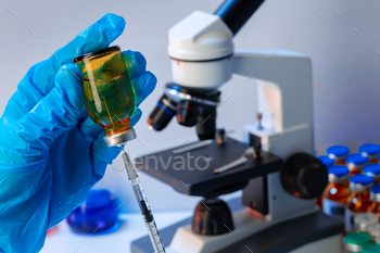 Doctor hands holding glass vial with medication / Photodune, Misc
