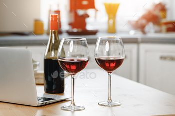 Two wine glasses with red wine on wooden kitchen counter / Photodune, Misc