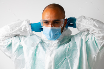 African american man doctor in medical protective gown and mask on white background / Photodune, Misc
