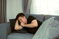 Asian people feel unhealthy while lying on the sofa at home while he have a cough due to bronchitis. - PhotoDune Item for Sale
