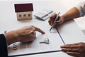 New home buyers are signing a home purchase contract at the agent's desk. - PhotoDune Item for Sale