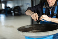 Mechanic in uniform is changing oil and fuel filter - PhotoDune Item for Sale