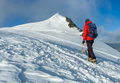 Mountaineer climbs a snowy peak in swiss Alps. Zermatt, Switzerland. - PhotoDune Item for Sale
