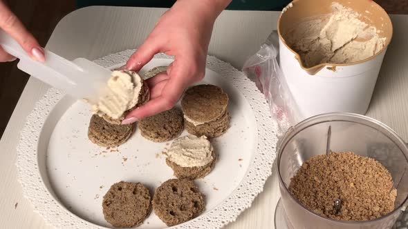 A Woman Makes A Biscuit Cake. Applies Butter Cream To The Workpieces. Overall Plan.