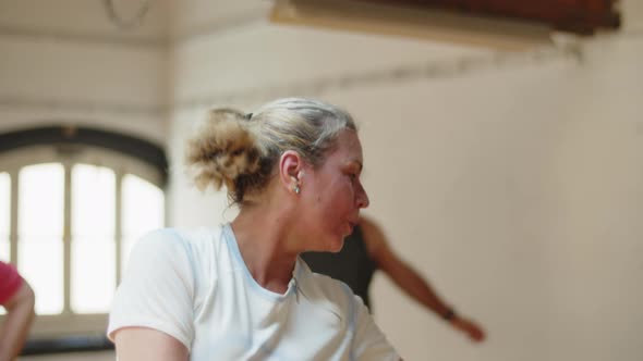 Medium Shot of Senior Woman Doing Physical Exercises in Ballroom