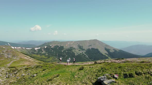 The Four Tourists Standing on the Mountain Top