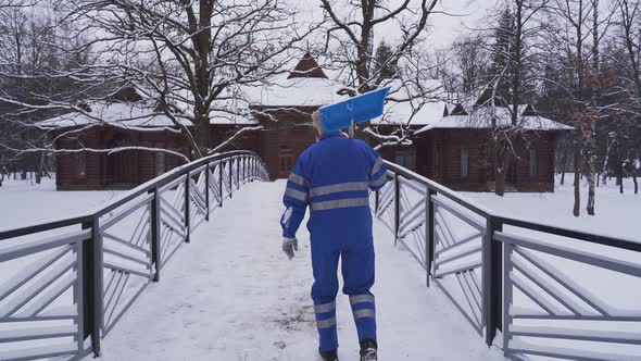 Old Cleaner Going Home with Shovel.