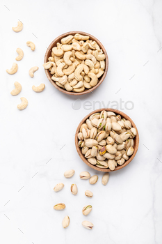 Cashew and pistachios nuts in wooden bowls / Photodune, Misc