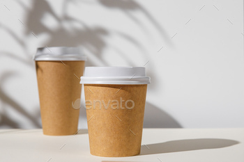 Takeout coffee cup with foliage shadows, copy space / Photodune, Misc