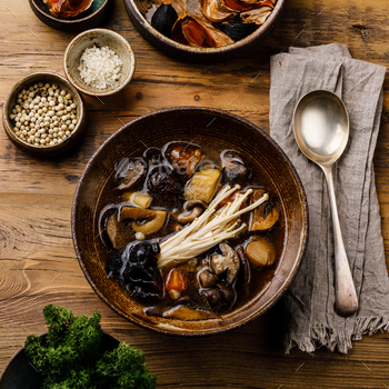 Healing Soup with roots, mushrooms and barley on wooden table background / Photodune, Misc