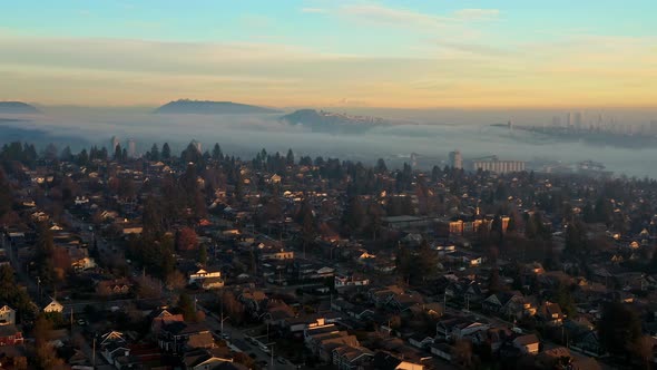 Quiet Neighborhood In North Vancouver City With Misty Mountain Landscape In The Background In Canada