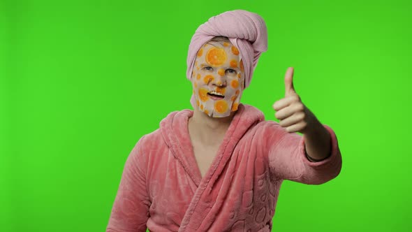 Transsexual Man in Bathrobe with Face Mask Giving Thumbs Up. Chroma Key