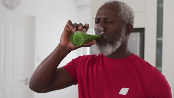 Senior african american man drinking fruit and vegetable health drink at home