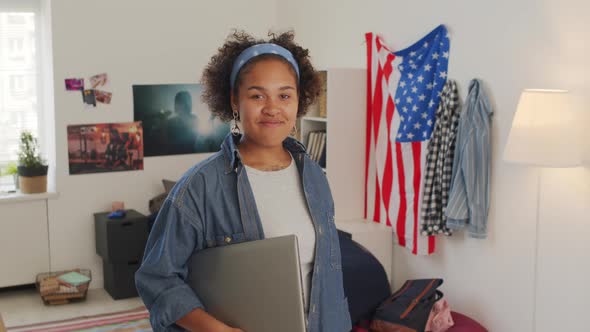 Girl with Laptop Posing in Bedroom