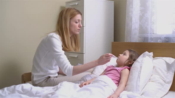 Mom is Measure the Temperature of Little Girl